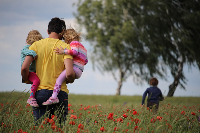 Dad with kids in field of flowers